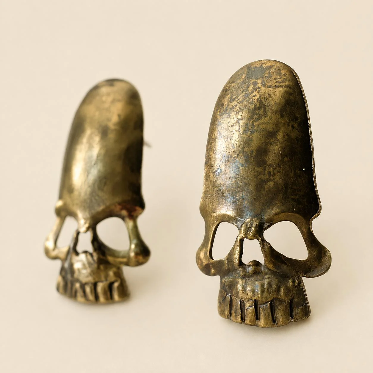 Pair of cast brass skull ornaments