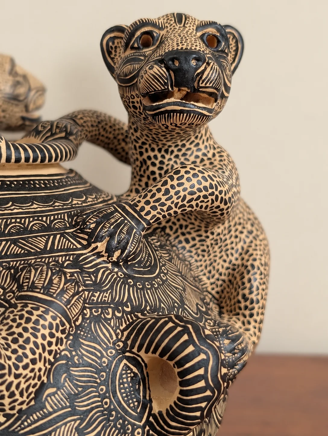 Incised jaguar vessel in burnished clay