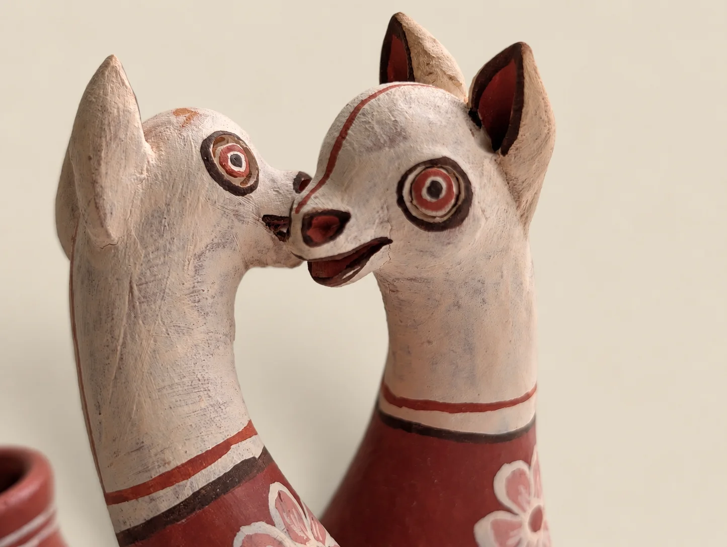 Double-headed llama vessel in red clay