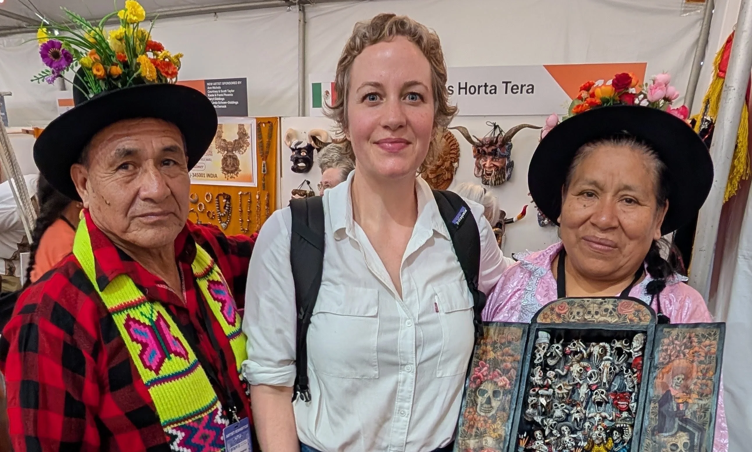 Rhi Devine with retablo artists Claudio Jiménez Quispe and Vicenta Flores Ataucusi at the International Folk Art Market, Santa Fe